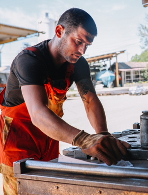 Blue collar worker in an orange apron focusing on his task representing the Citizen archetype of hard work and equality