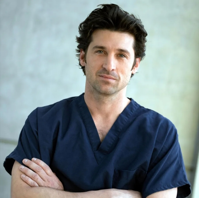 Male doctor in scrubs with folded arms, symbolising care, trust, and compassion