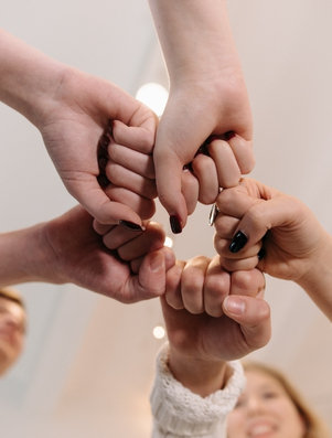 Hands joining together in solidarity representing the Citizen archetype of fairness and community