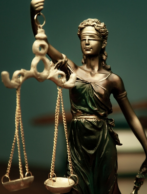 Lady Justice statue holding balanced scales representing the Sage archetype of truth, wisdom, and fairness