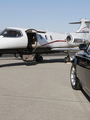 Private jet and luxury car on a runway representing the Ruler archetype of power travel and prestige