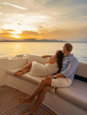 Couple embracing on a yacht at sunset representing the Lover archetype of intimacy and indulgence