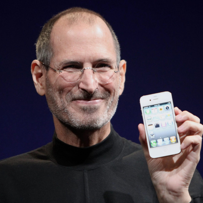 A visionary innovator smiling and holding up a sleek smartphone during a product launch, symbolizing transformation and groundbreaking ideas.