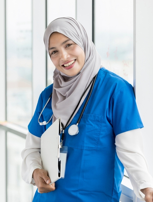 Smiling nurse in blue scrubs with a stethoscope representing the Caregiver archetype of compassion and healing