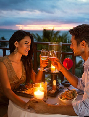 Couple enjoying a candlelit dinner with wine representing the Lover archetype of romance and connection